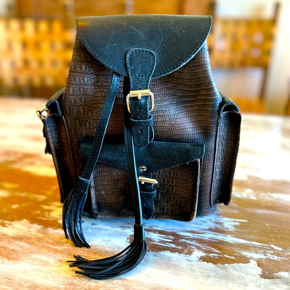 Freebird brown distressed leather backpack, w/black straps & drawstring w/snaps.